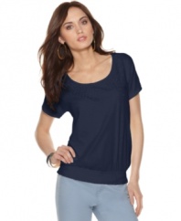 Simple styling with a glam touch: Calvin Klein Jeans' petite top features fabric pailettes and a deep scoop neckline.