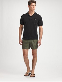 Comfortable swim trunks, in quick-drying nylon, are highlighted by a striped detail along the waistband and back flap pocket with grip-tape closure.Snap button-frontRear flap pocketInseam, about 3NylonMachine washImported