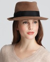 A rabbit fur velour fedora with a grosgrain bow accent adds edgy style to your next ensemble.