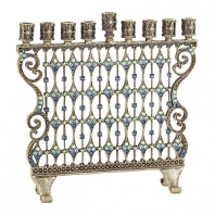 A luxe essential for celebrating the holidays, this menorah glitters with hundreds of blue and green hand-set Swarovski® crystals set in antiqued brass.