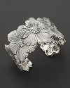 Delicate gardenias, captured at the height of their beauty in sterling silver, overlap on this shining cuff from Buccellati.