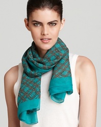 A sheer silk woven scarf with a classic plaid pattern and contrast green border.