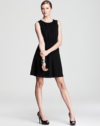 A sleek city basic, this DKNY dress gains feminine flair with delicate pleats and sheer styling. Sky-high pumps inject the style with provocative edge.