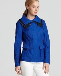 Fusing utility with fashion, this T Tahari jacket blazes through the season in a brilliant shade of blue. A color-block collar lends the perfect finishing touch, just unzip it to reveal to a hidden hood.