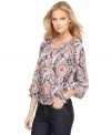 The only thing more ornate than the print of this petite MICHAEL Michael Kors peasant top is the design detail, which includes a romantically billowy silhouette and a smocked waist for just the right dash of definition.