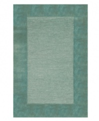 A looped center of mottled tones is framed by rich color in tufted pile, presenting a modern area rug that is both casual and practical. Hand tufted in India of pure wool fibers, the Madrid area rug is a comforting, stylish addition to any decor.